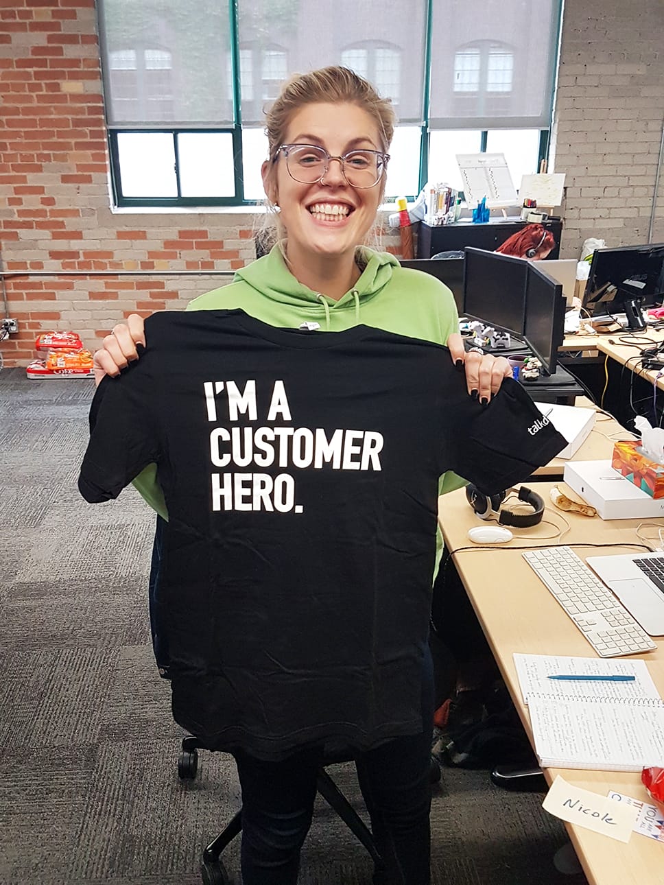 A friendly customer support professional smiling in a creative office
